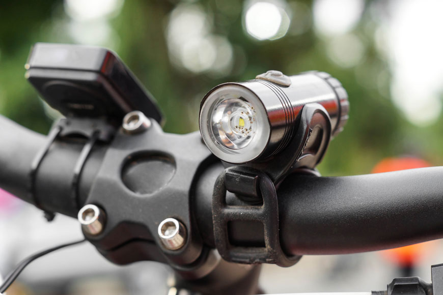 Close-up of handlebars with front LED strobe light