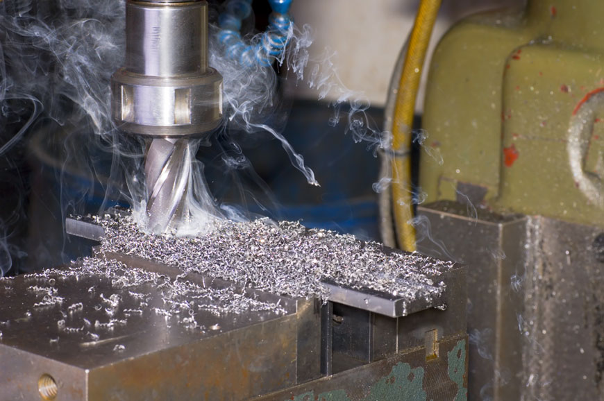 Smoke comes out of a borer drilling into metal.