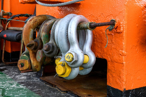 different types of shackles hanging on a wire rope hanger