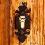 old cylinder lock in wooden door