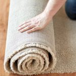 person rolling a new carpet